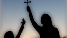 reaching for cross, woman holding cross